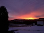 red sky over snowy fields