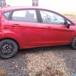 red car with no wheel covers
